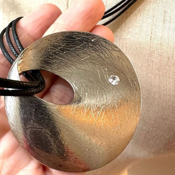 Round silver tone pendant necklace on long black cord - Picture 4 of 10